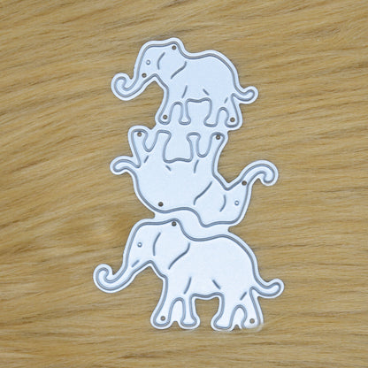 Elephant family metal cutting die set with three separate elephant designs shown on faux fur background for card making crafts