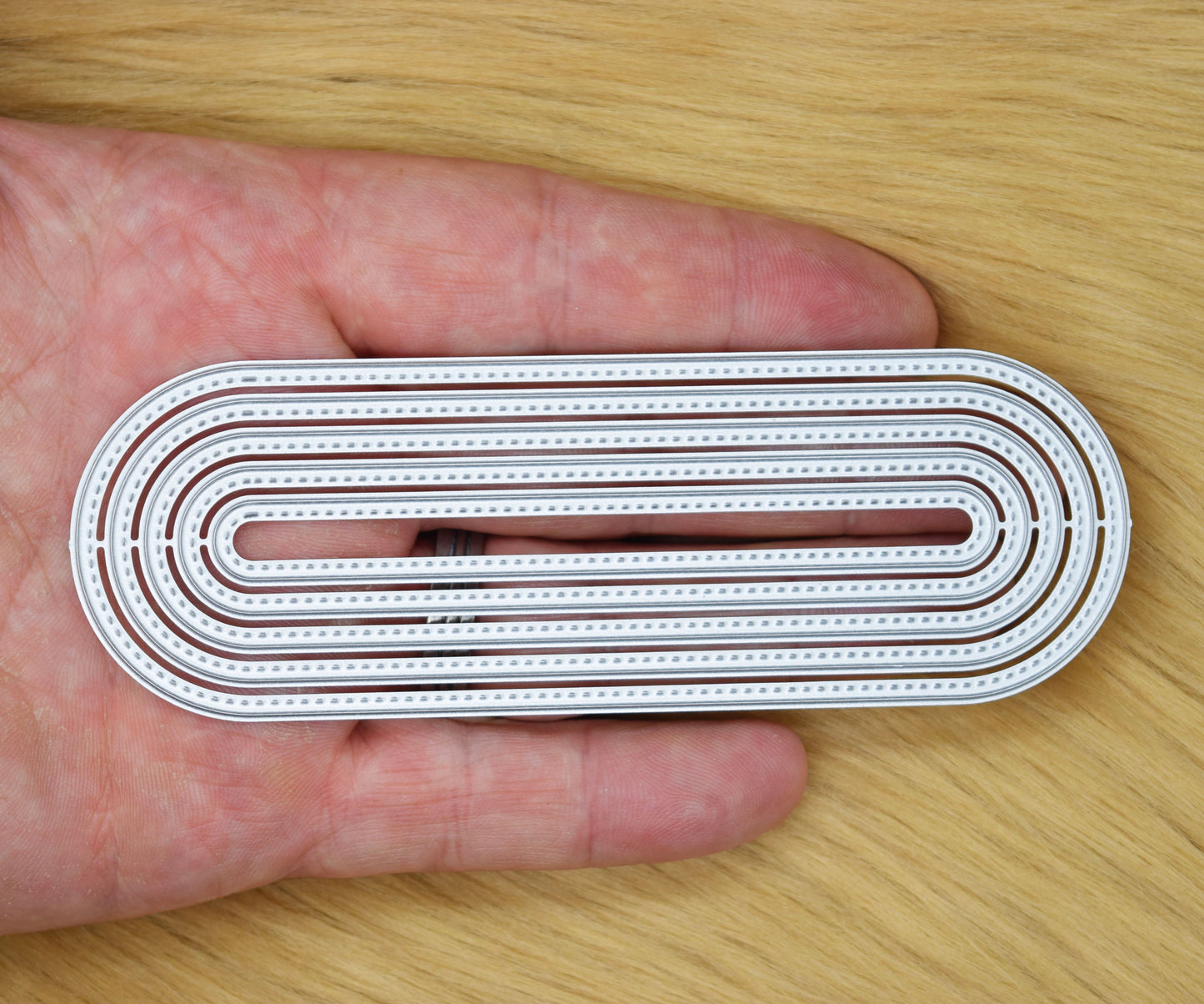 Elongated oval metal cutting dies set showing stitched border detail and slimline proportions