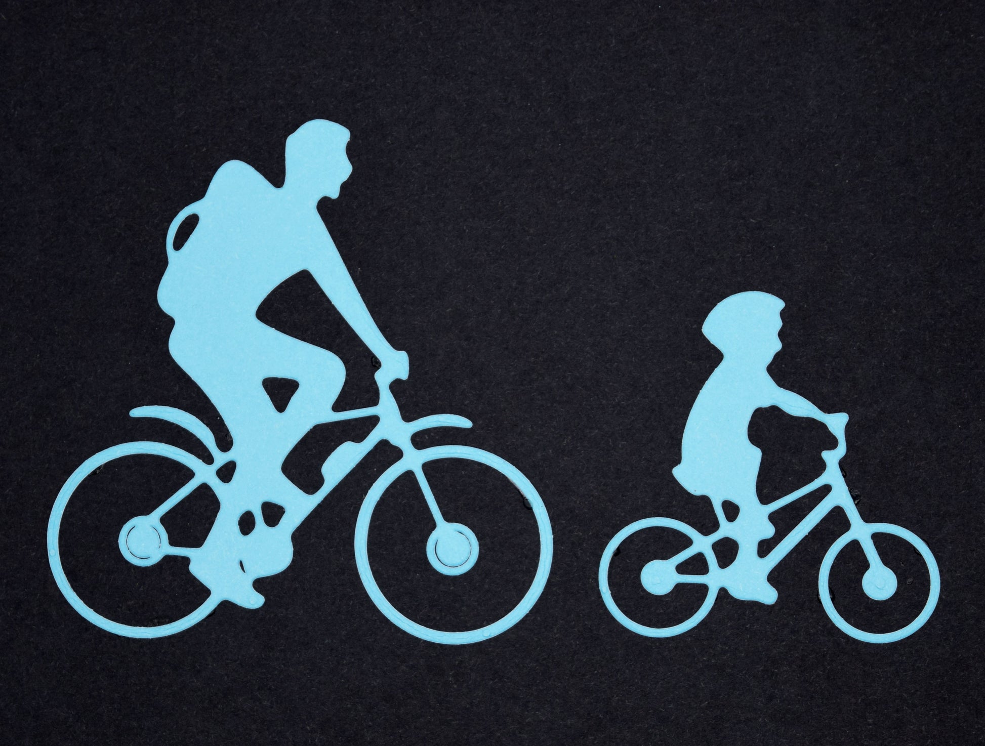 Blue family bicycle die cuts featuring adult and child cyclists for sports themed card making and paper craft projects