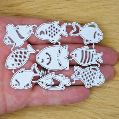 Fish metal cutting dies set shown in hand for size scale
