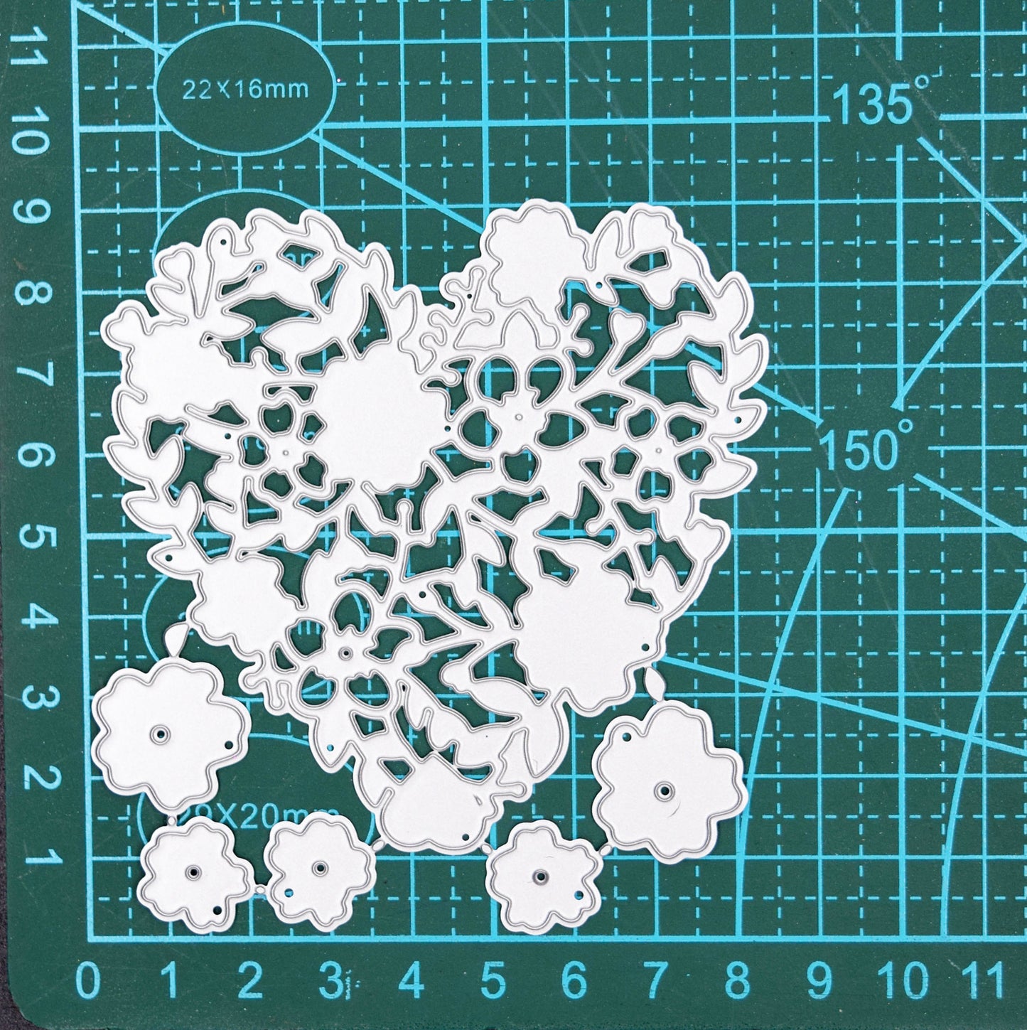 Floral heart metal cutting die set on cutting mat showing size
