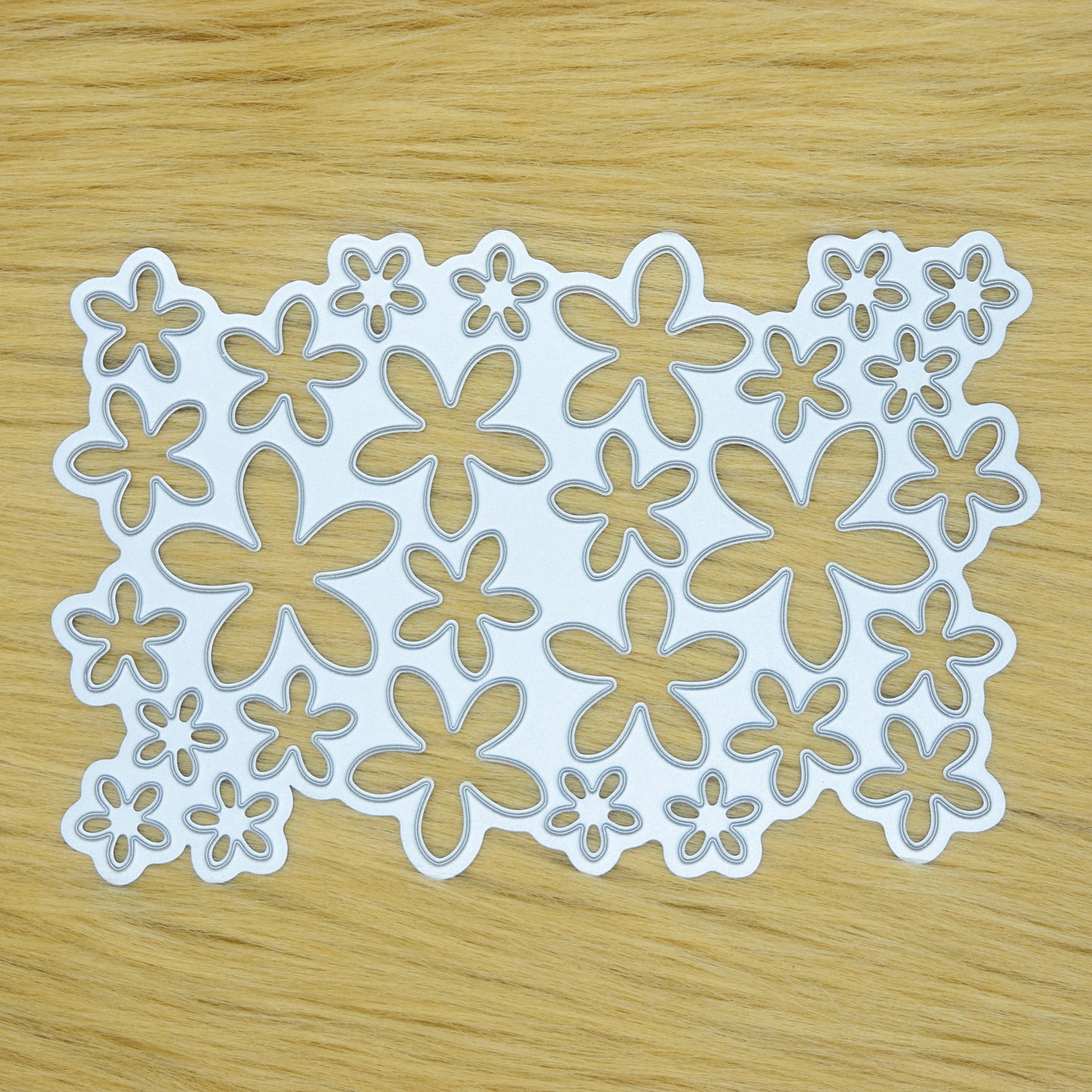 Flower petal background cutting die on faux fur surface
