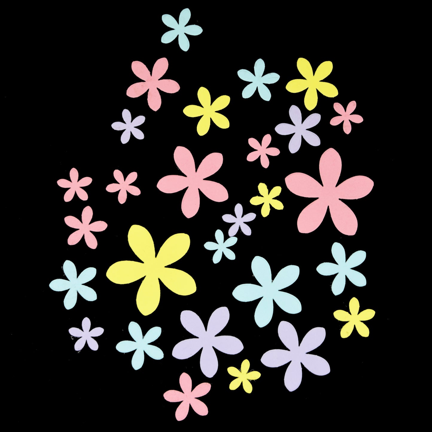 Multiple flower shapes cut from pastel card using background die