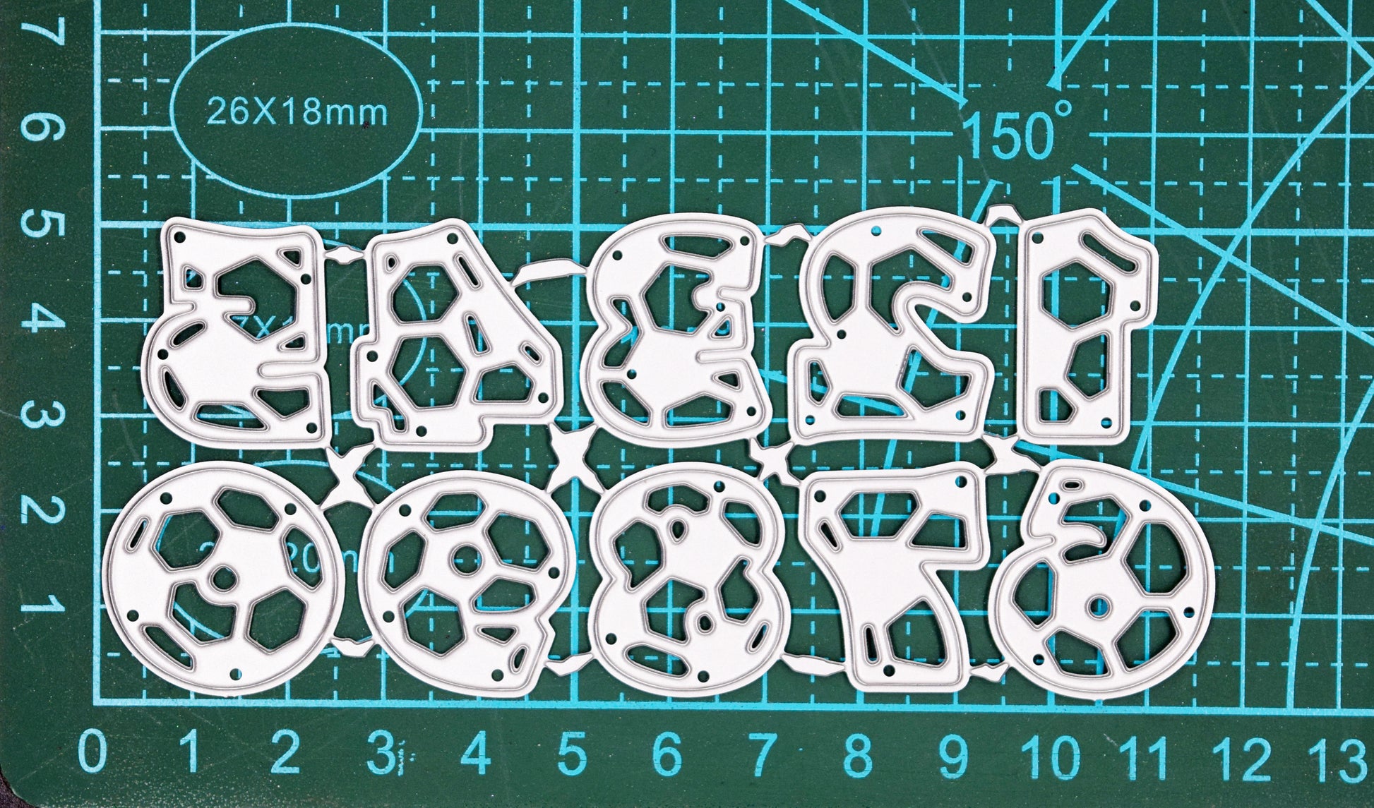 Football number metal cutting dies on measuring mat showing size