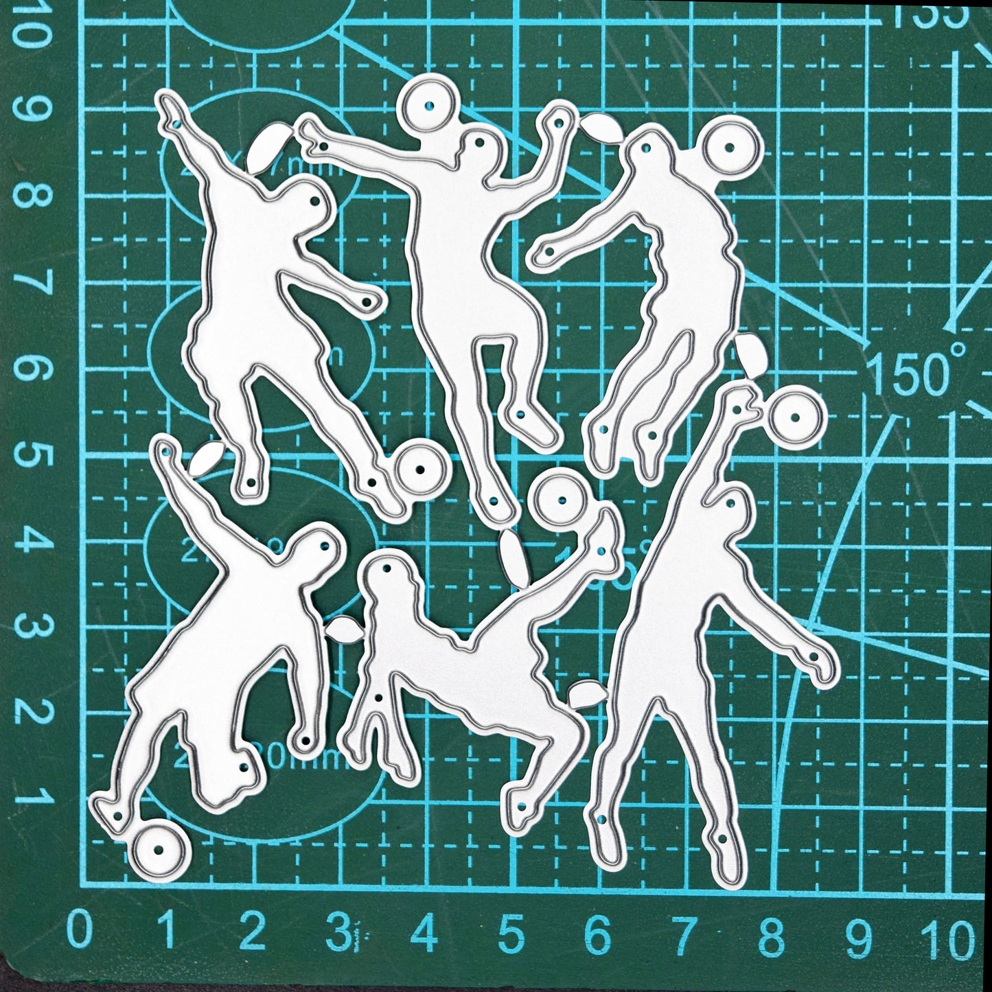 Football player metal cutting dies shown on a cutting mat for size reference