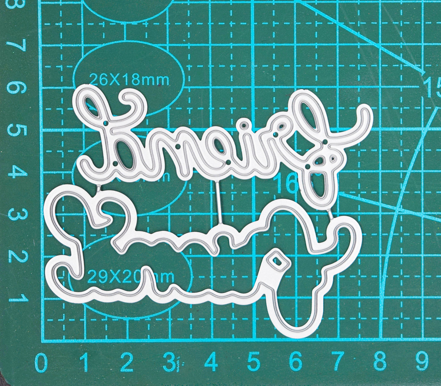 Layered Friend script word cutting die set shown on measuring mat for size reference