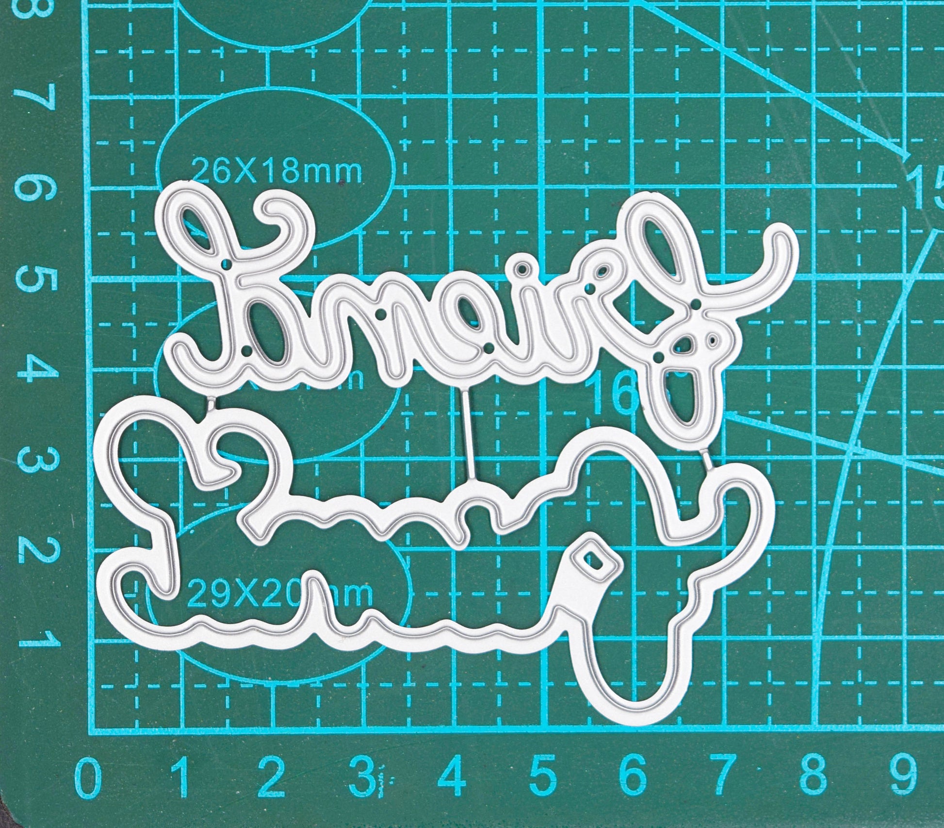 Layered Friend script word cutting die set shown on measuring mat for size reference