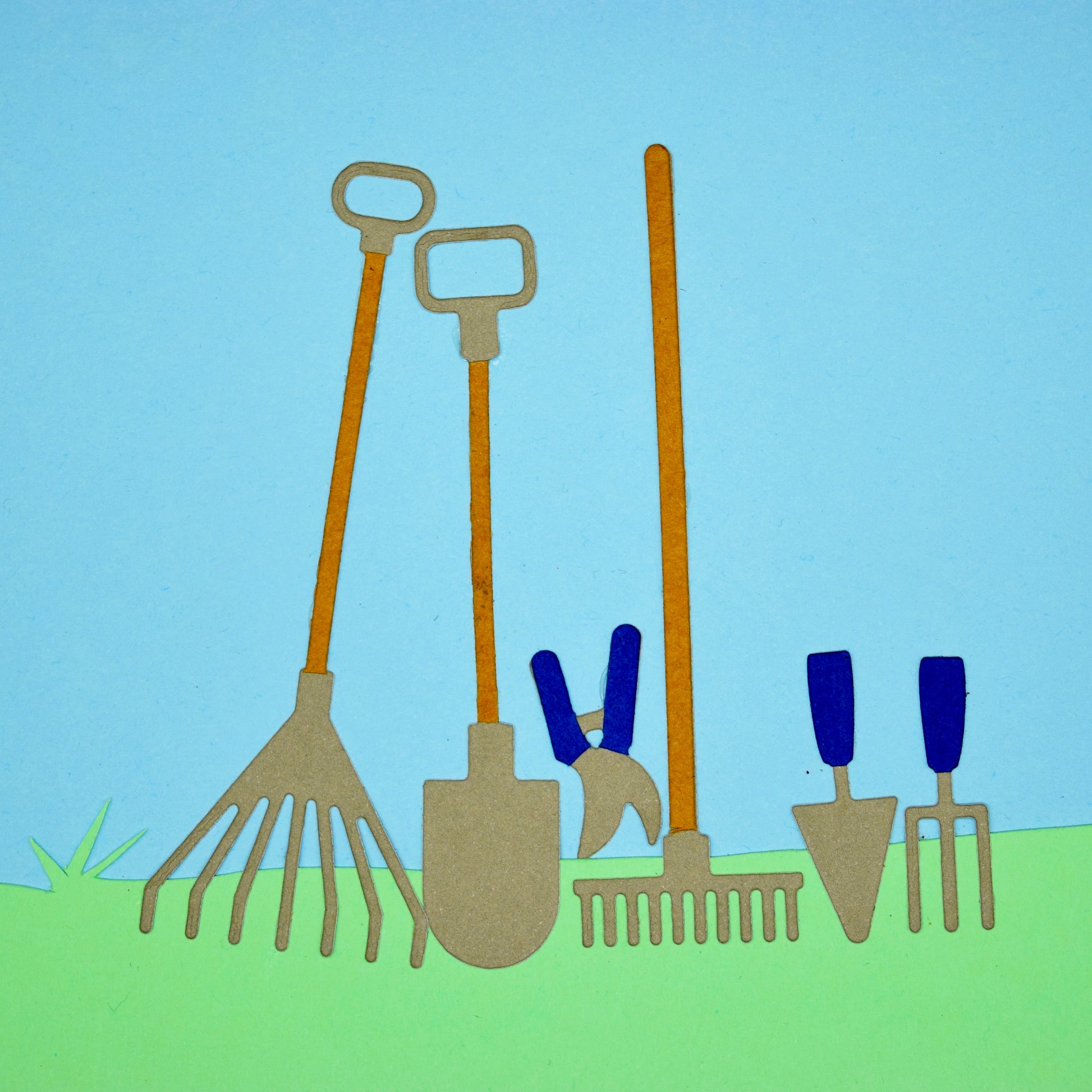 Garden hand tool die cuts made from coloured cardstock including a shovel, rake, fork, trowel and secateurs