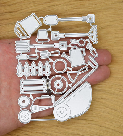 Gardening tools metal cutting dies set held in hand to show size for card making and papercraft use