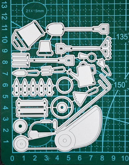 Gardening tools metal cutting dies set placed on cutting mat for size reference in papercraft projects