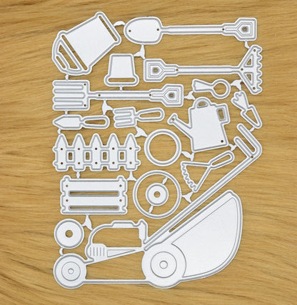Full gardening tools metal cutting die set arranged on surface showing lawn mower, watering can and garden tools