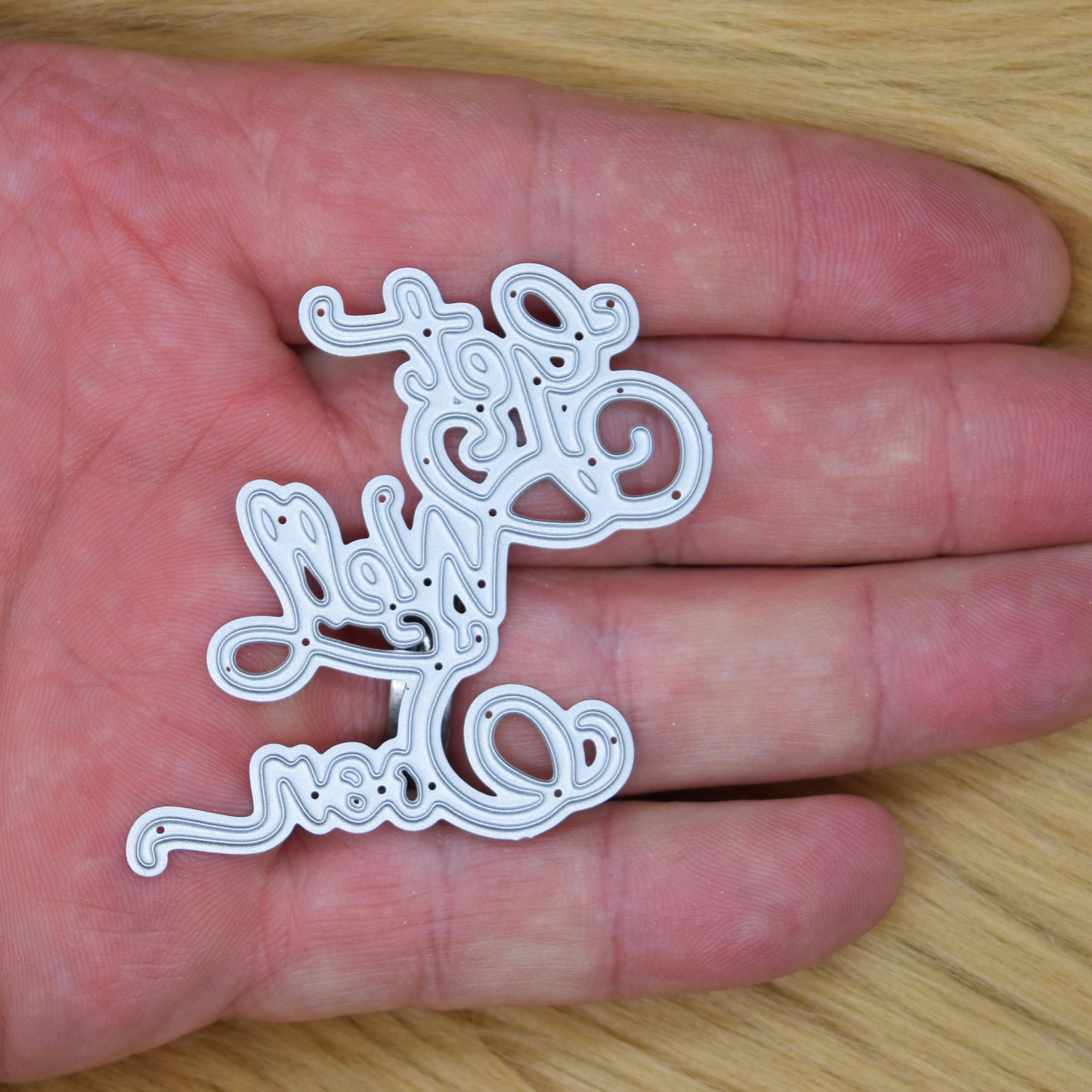 Get Well Soon script metal cutting die shown in hand for size reference suitable for handmade greeting cards and papercrafts