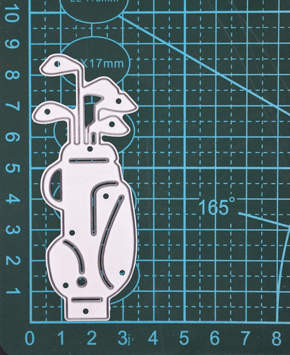 Golf bag metal cutting die on cutting mat showing golf clubs and bag design for card making