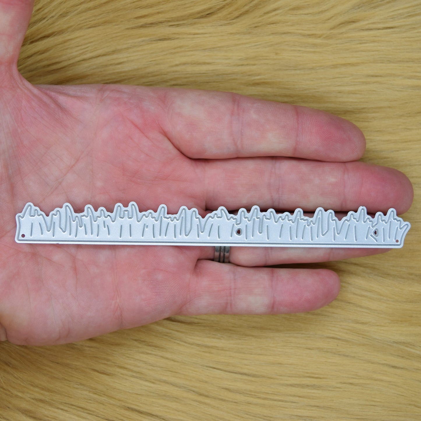 Grass border metal cutting die size reference shown in hand