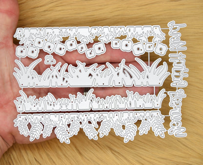 Grass border edging metal cutting dies shown in hand for papercraft and card making