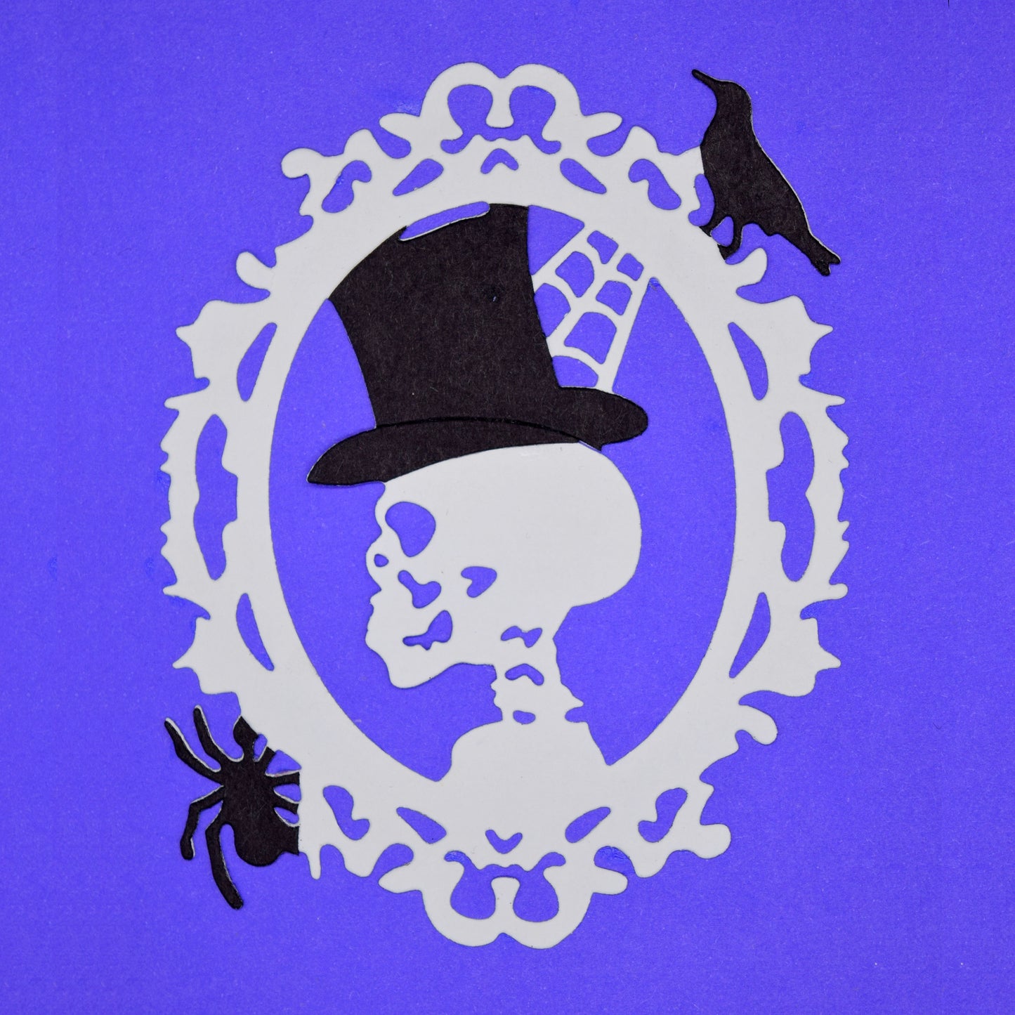 Halloween skull cameo die cut with top hat, spider and raven details