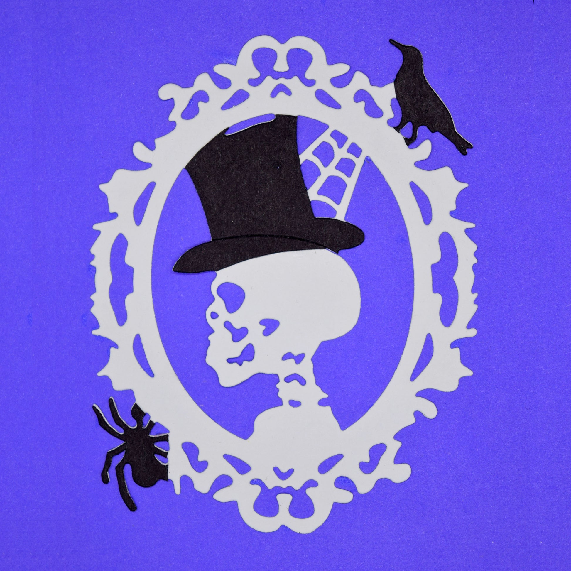 Halloween skull cameo die cut with top hat, spider and raven details
