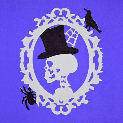 Halloween skull cameo die cut with top hat, spider and raven details