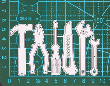 Hand tools metal cutting die set shown on a cutting mat for scale with six workshop tool designs.
