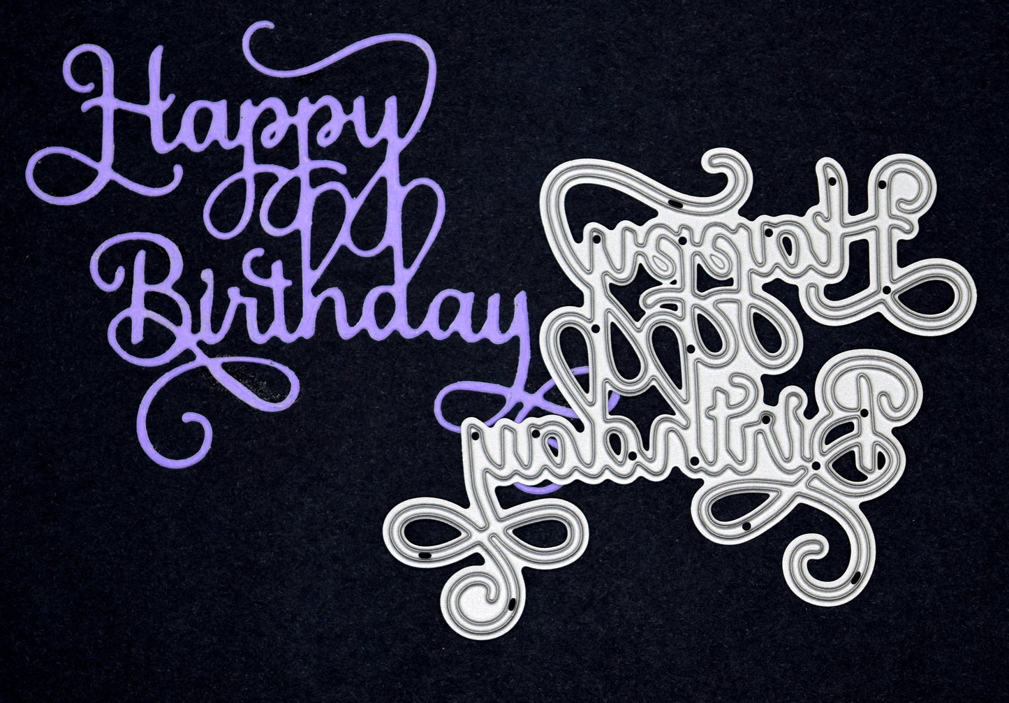 Happy Birthday die cut sentiment in purple card alongside matching metal cutting die with elegant calligraphy swirls for handmade birthday cards