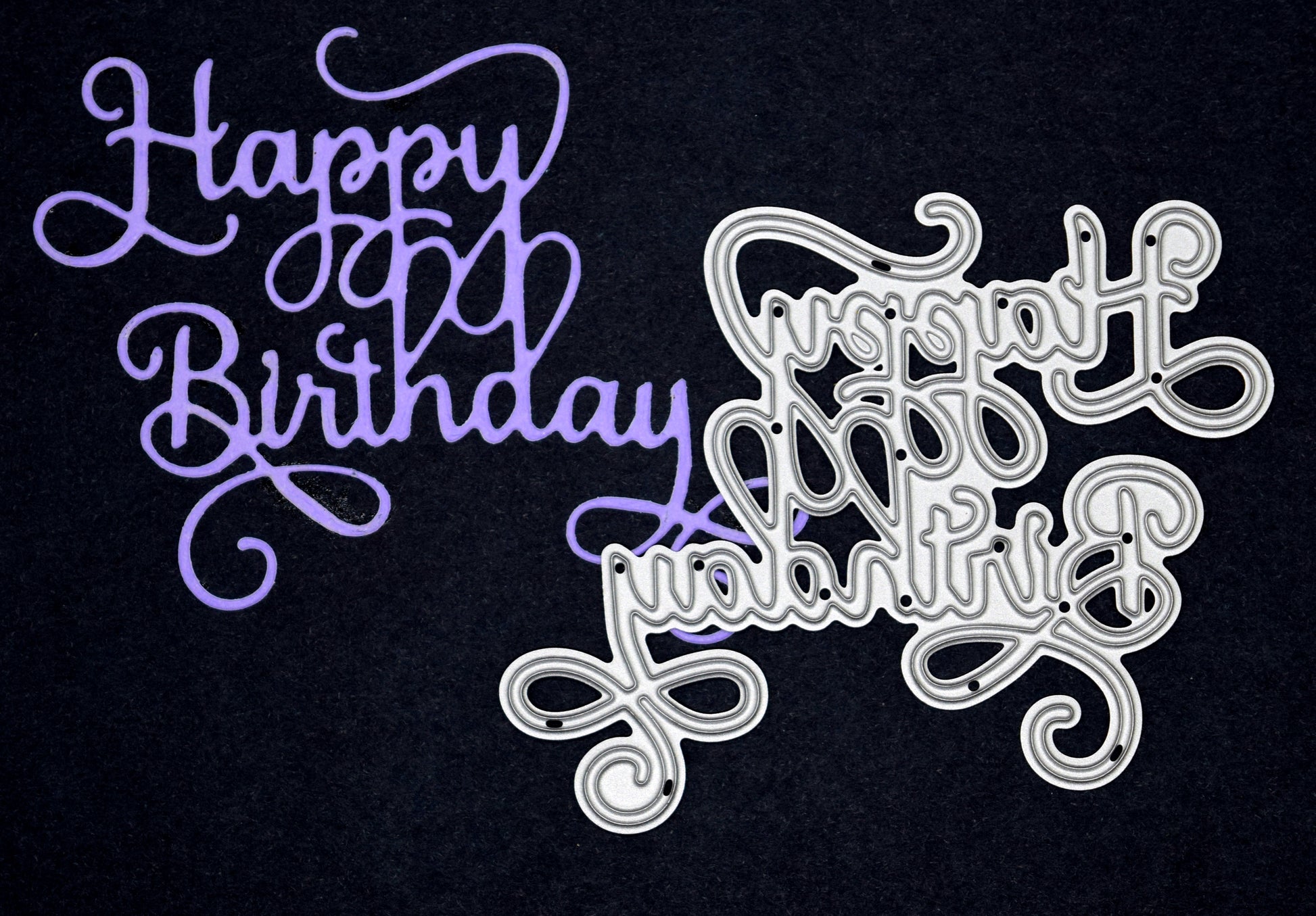 Happy Birthday die cut sentiment in purple card alongside matching metal cutting die with elegant calligraphy swirls for handmade birthday cards