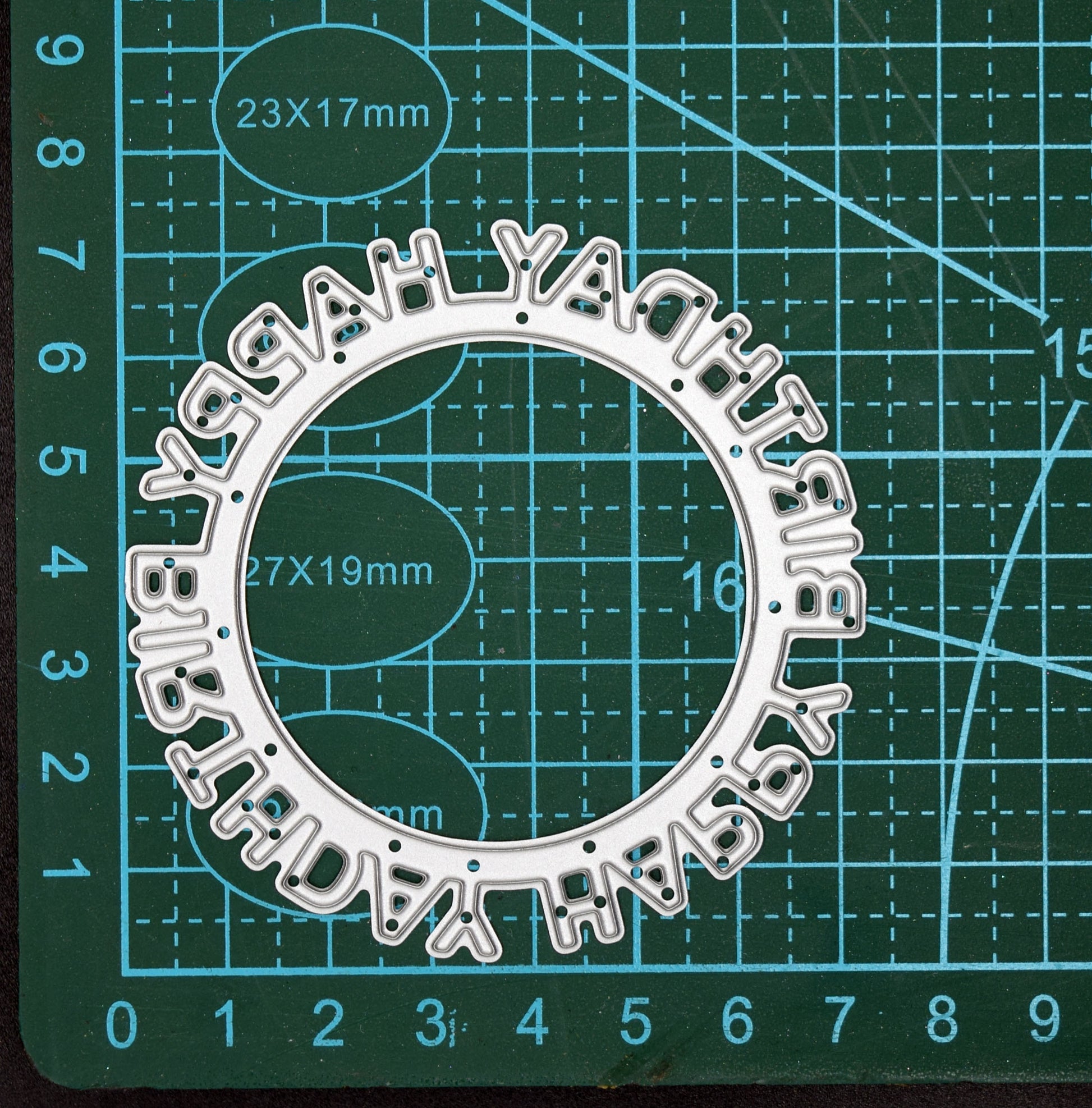 Happy Birthday circular frame metal cutting die on measuring mat showing size reference