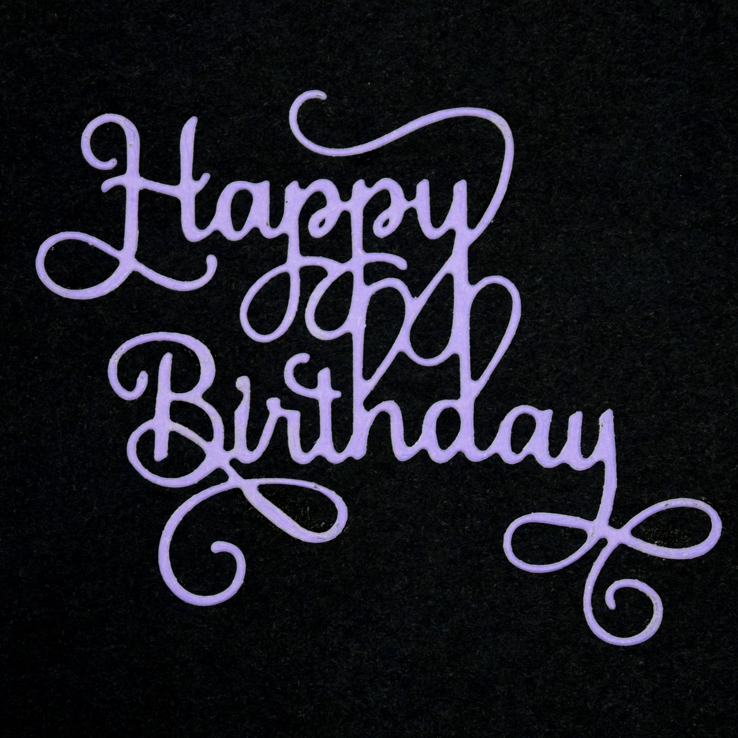 Finished Happy Birthday script die cut in purple card with elegant flowing calligraphy style for handmade birthday cards and papercrafts