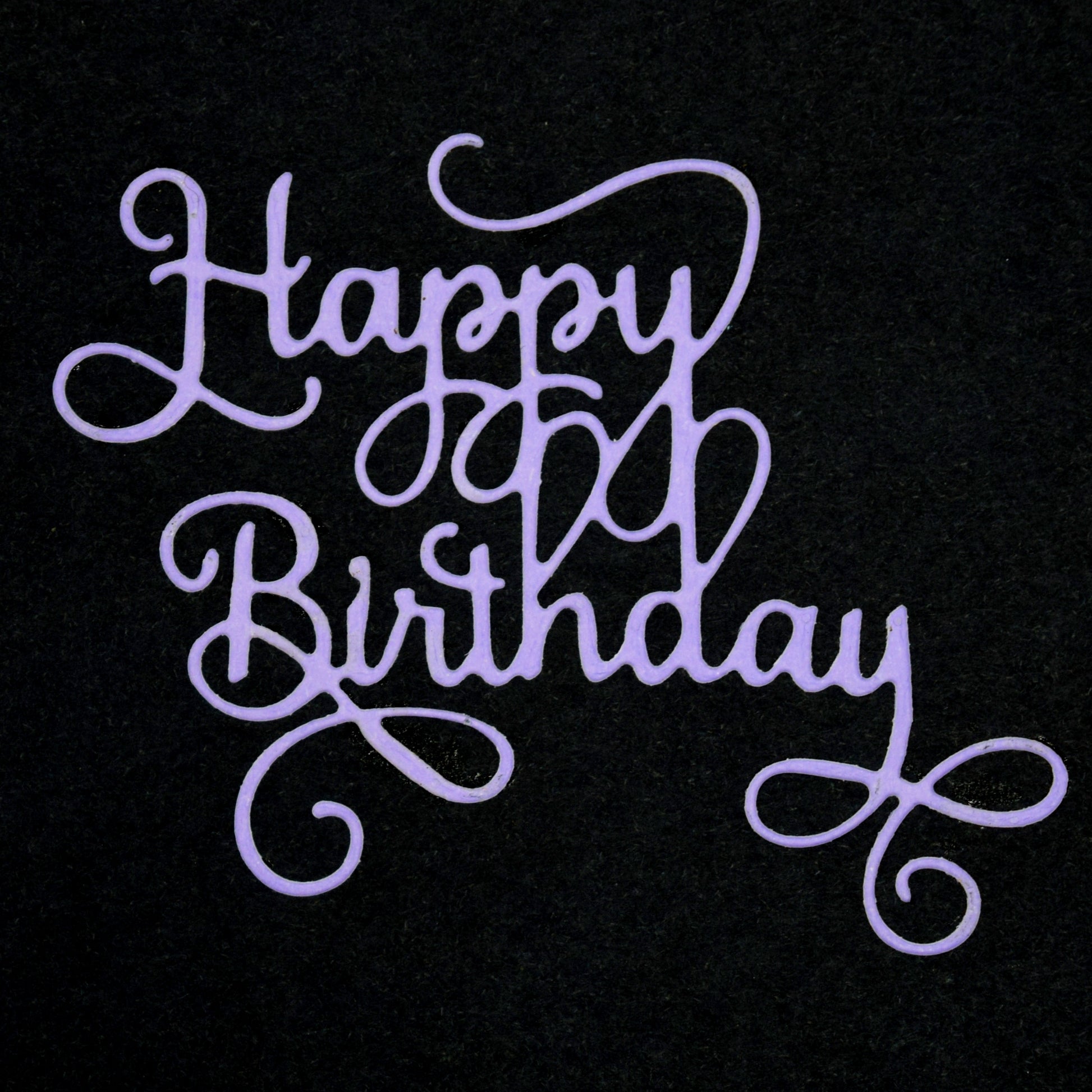 Finished Happy Birthday script die cut in purple card with elegant flowing calligraphy style for handmade birthday cards and papercrafts