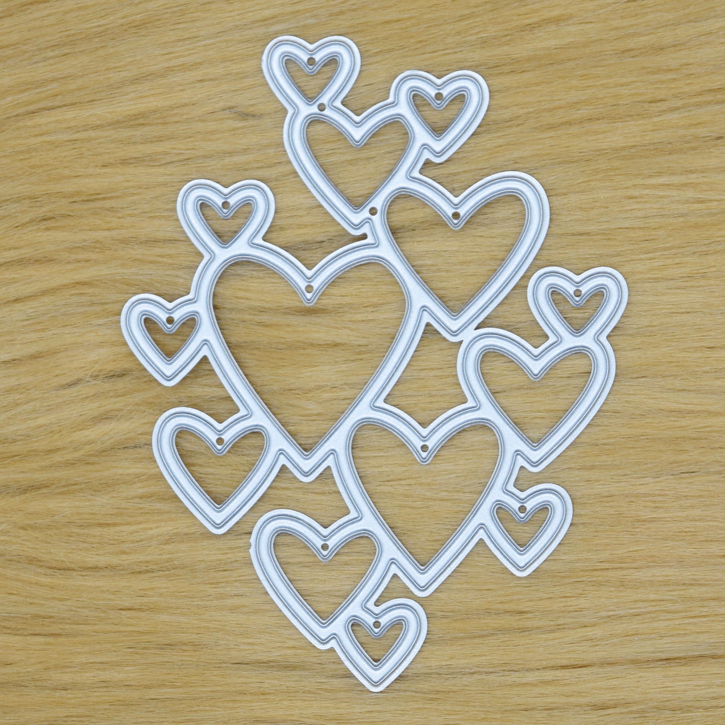 Heart cluster metal cutting die on faux fur background