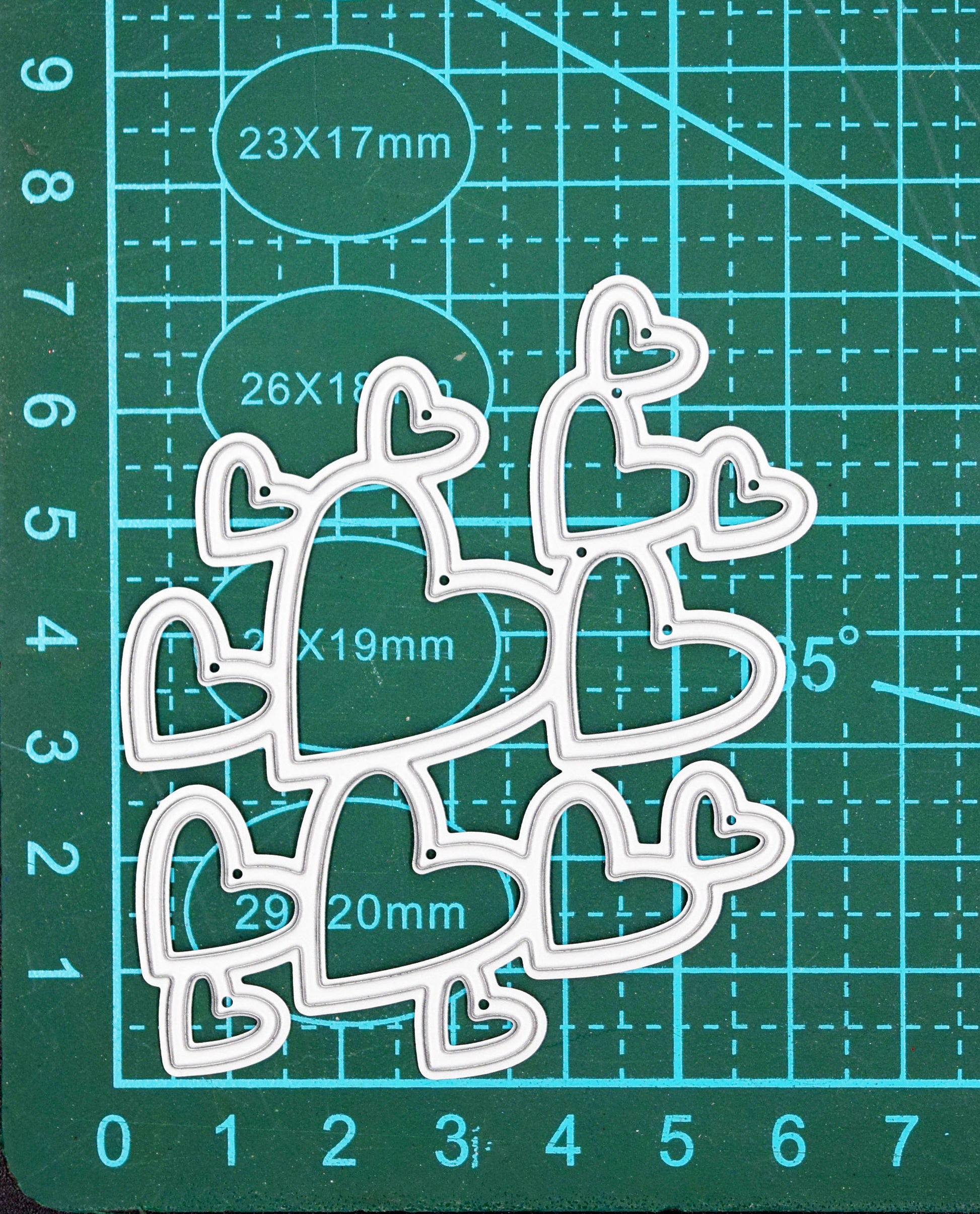 Heart cluster metal cutting die on cutting mat showing size