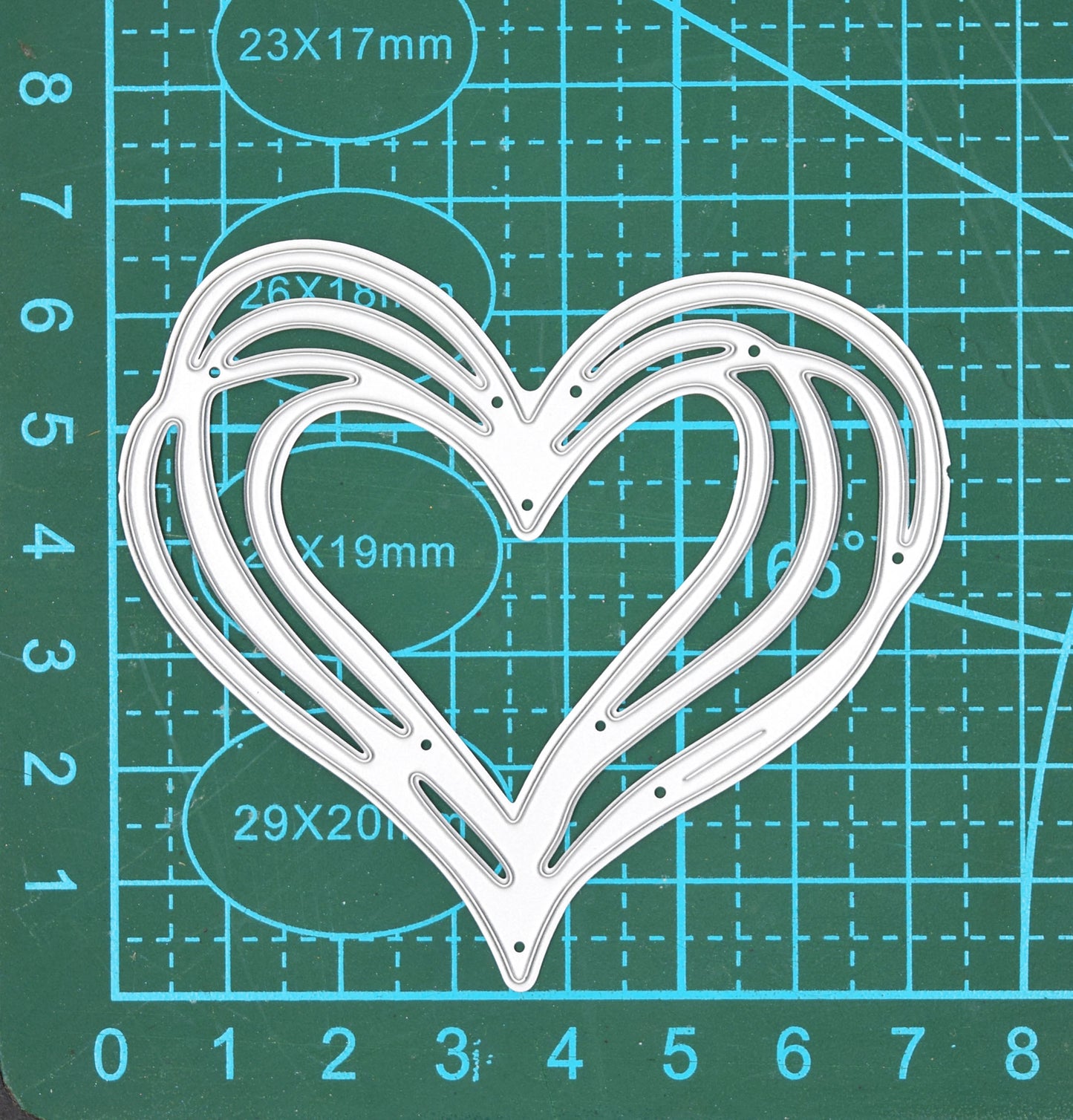 Heart metal cutting die on cutting mat showing size