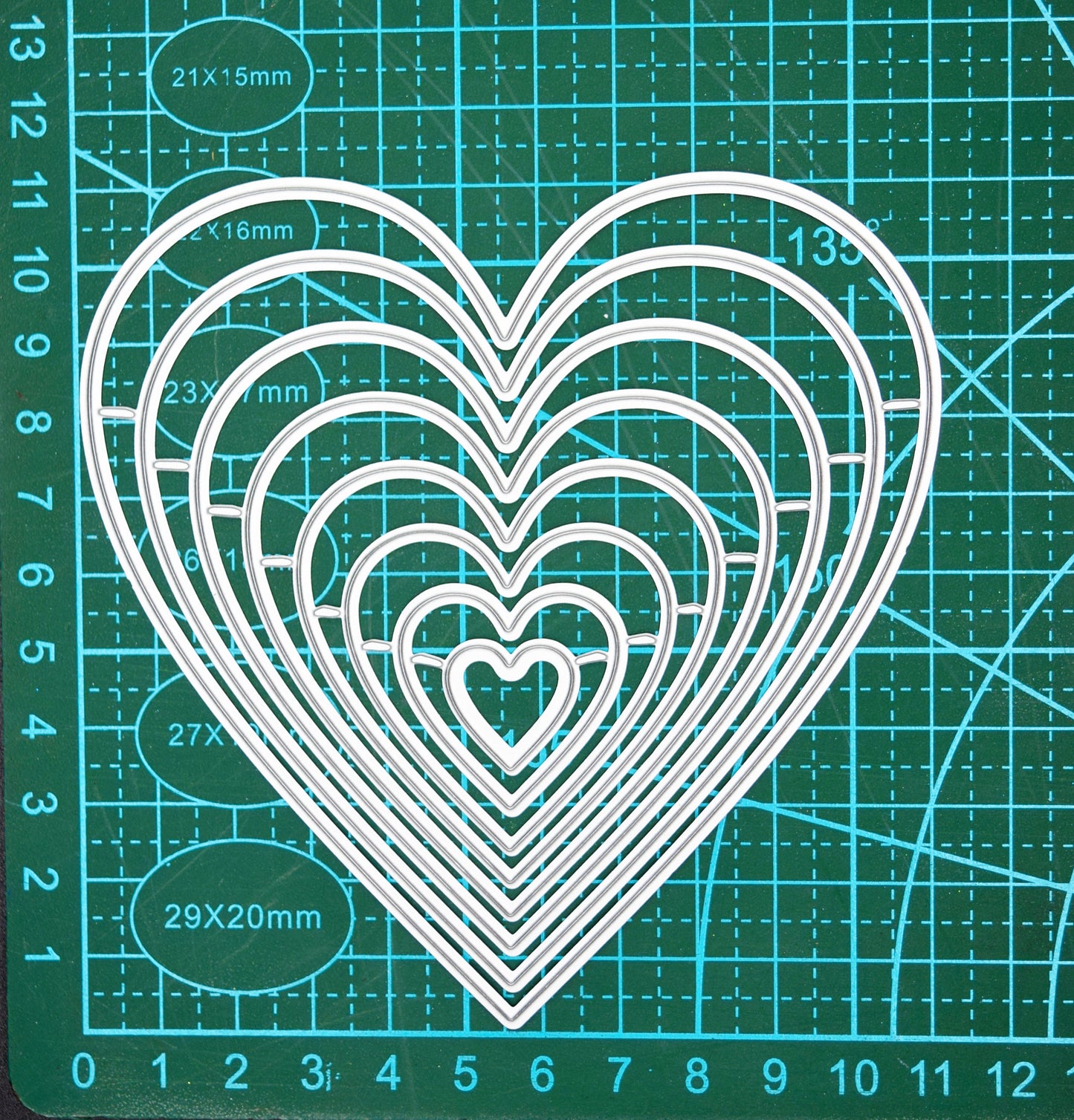 Heart nesting dies on cutting mat showing measurements