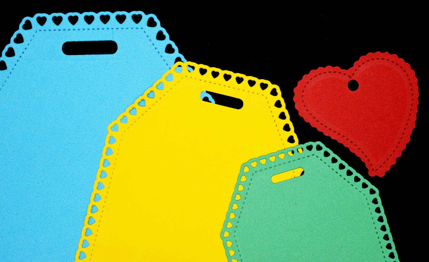 Heart tag die cut examples showing stitched edge and heart border