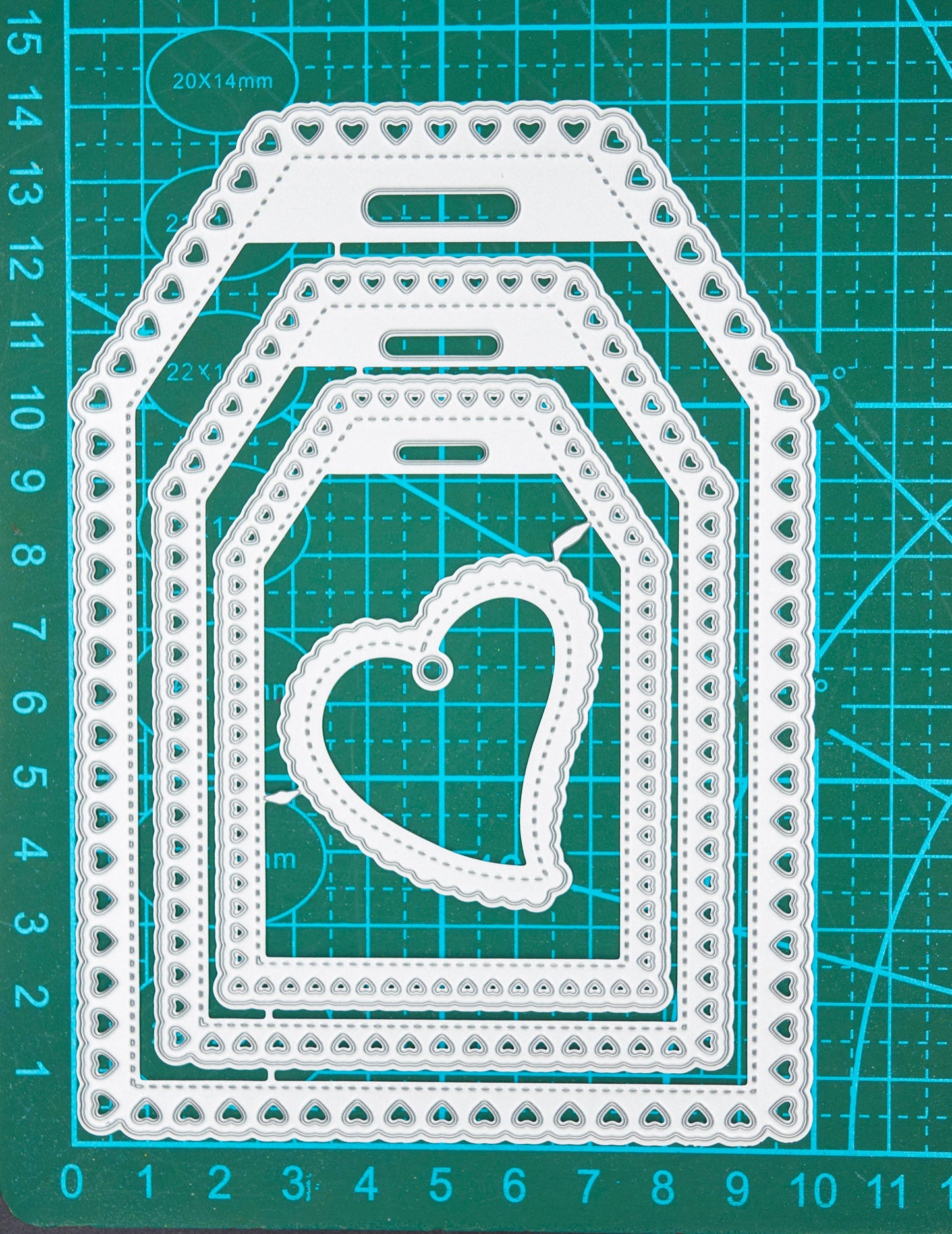 Heart tag metal cutting dies on cutting mat showing measurements