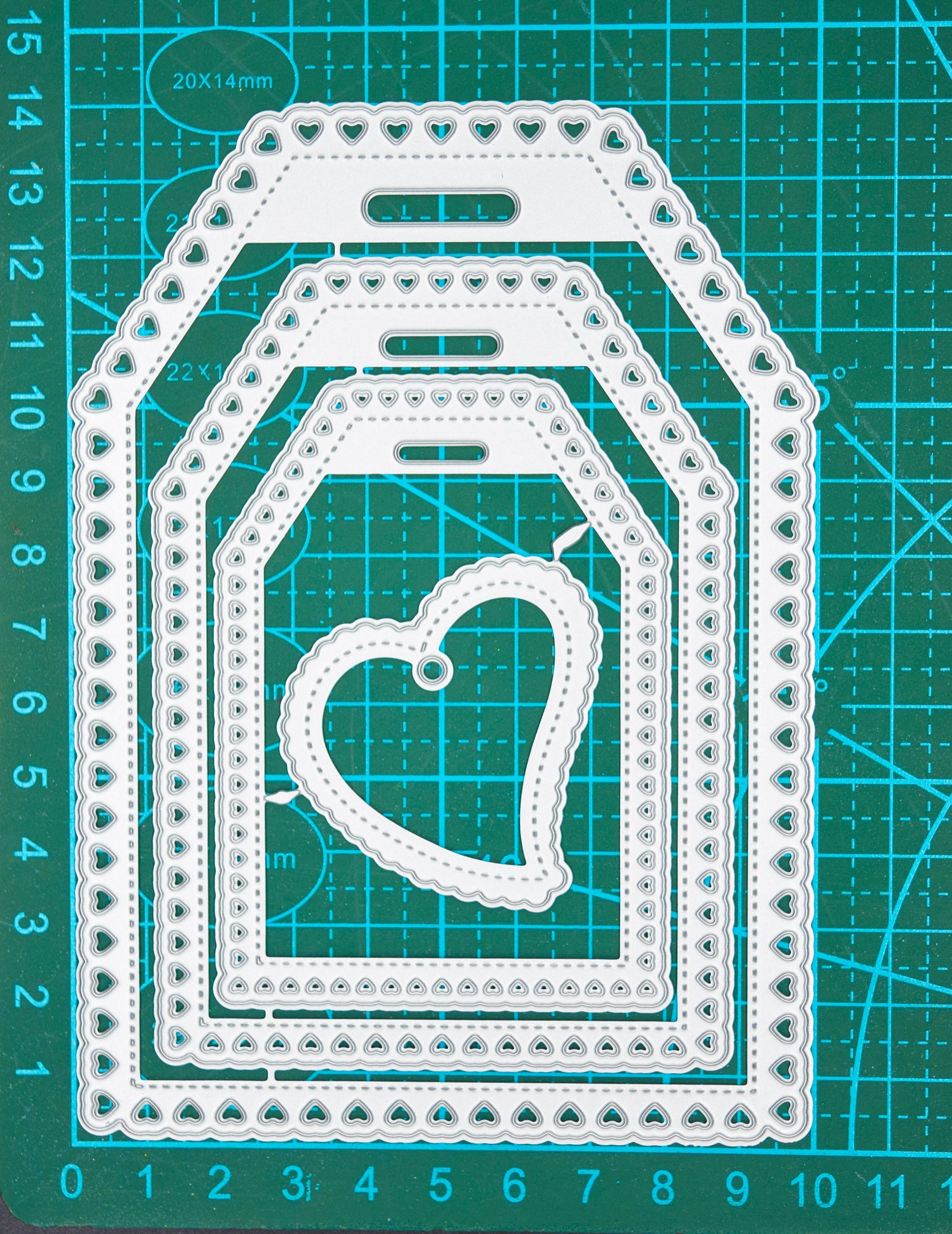 Heart tag metal cutting dies on cutting mat showing measurements