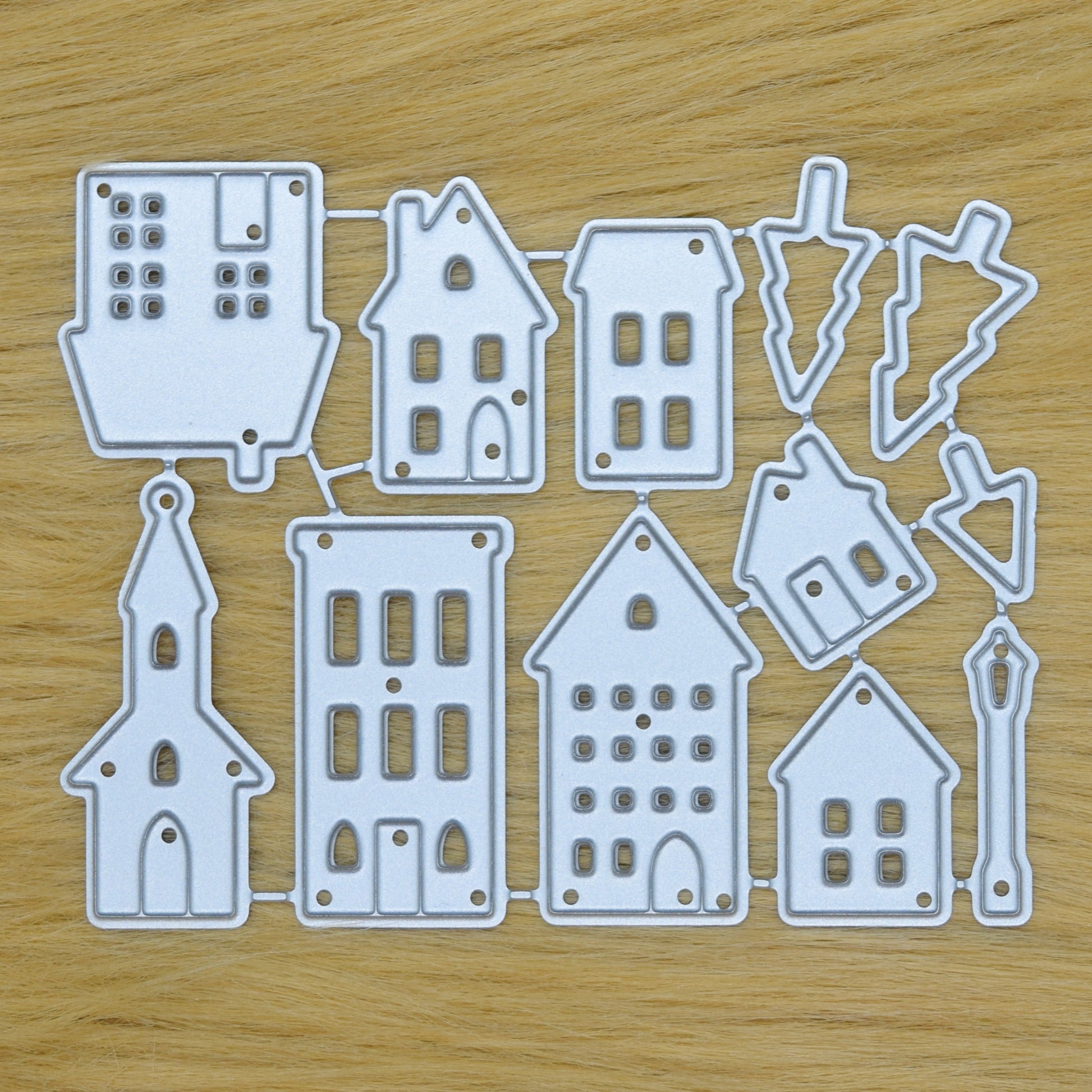 House and tree metal cutting dies set on faux fur background