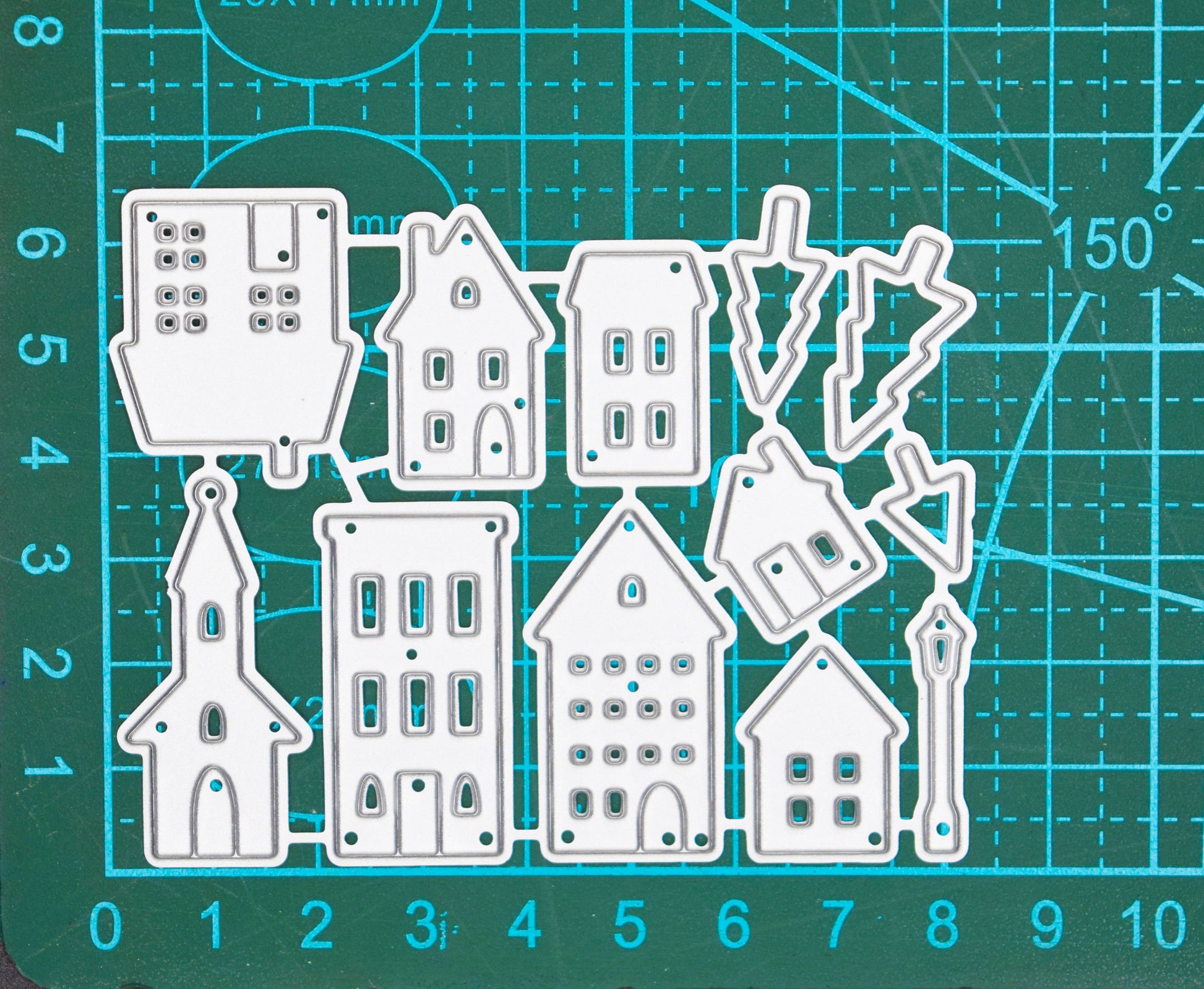 House and building metal dies on measuring mat showing size