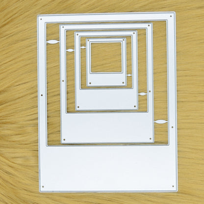 Set of four instant camera frame nesting metal cutting dies displayed on a light tan faux fur background