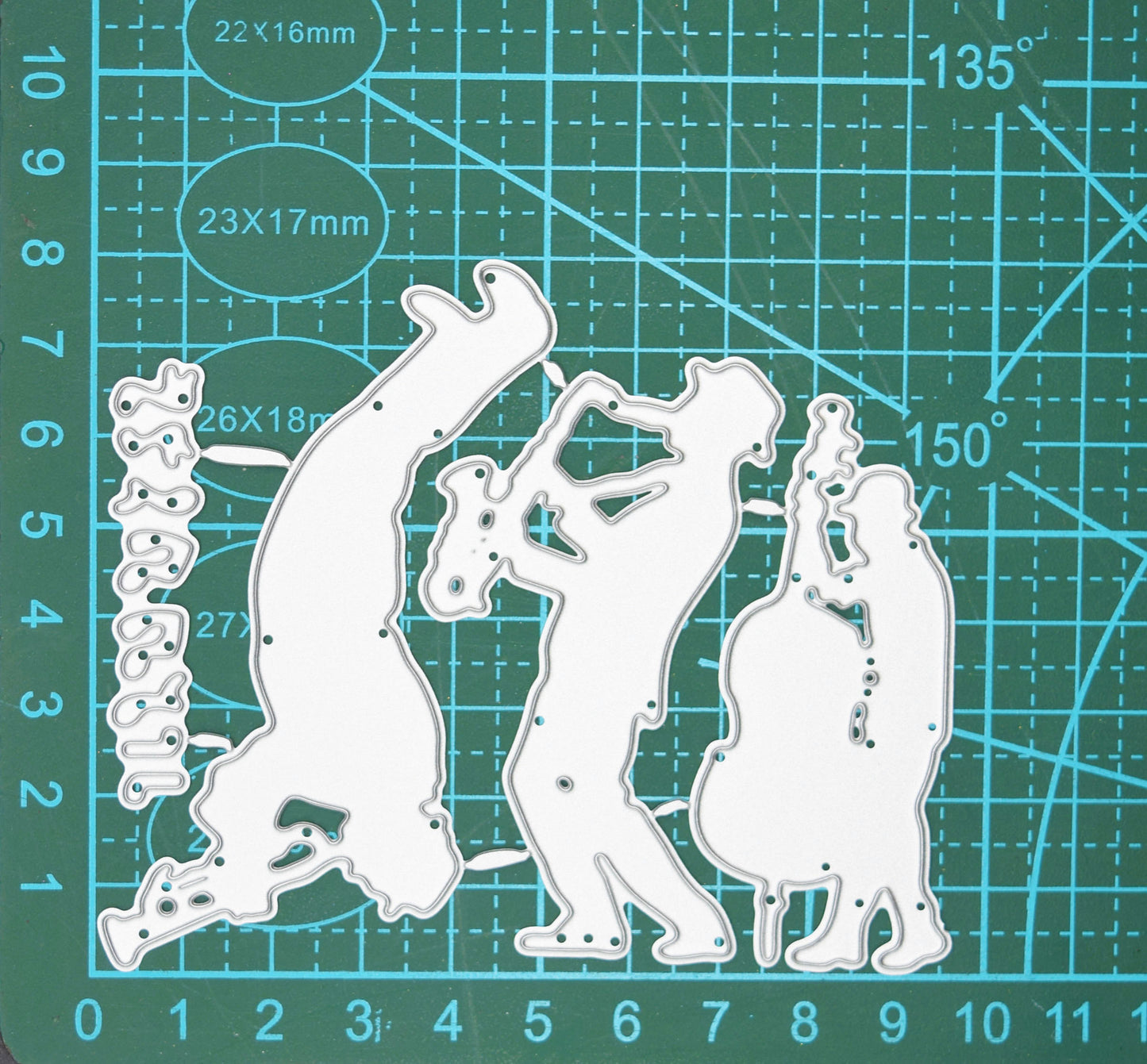 Jazz swing band and music notes metal cutting dies set displayed on a cutting mat to show scale for music-themed card making and paper crafting.