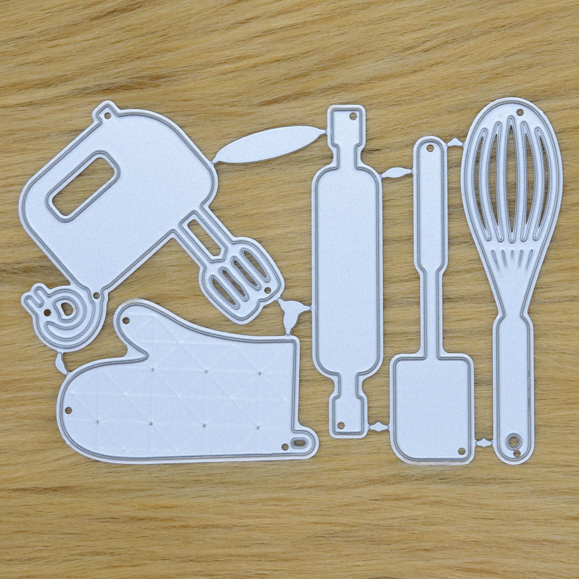 Kitchen utensil metal cutting dies set on faux fur background