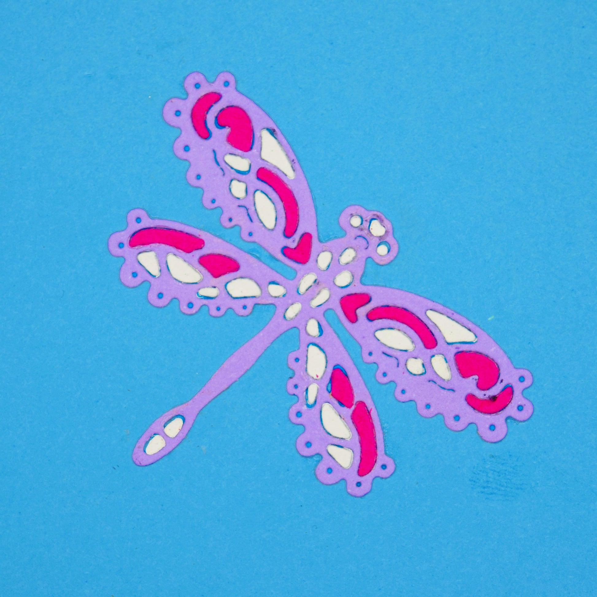 Decorative lace style dragonfly die cut in layered pink purple and white card for card making and papercraft projects