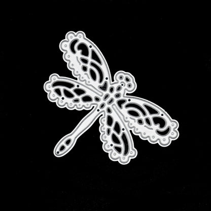 Decorative lace dragonfly metal cutting die photographed on black background for card making and craft projects