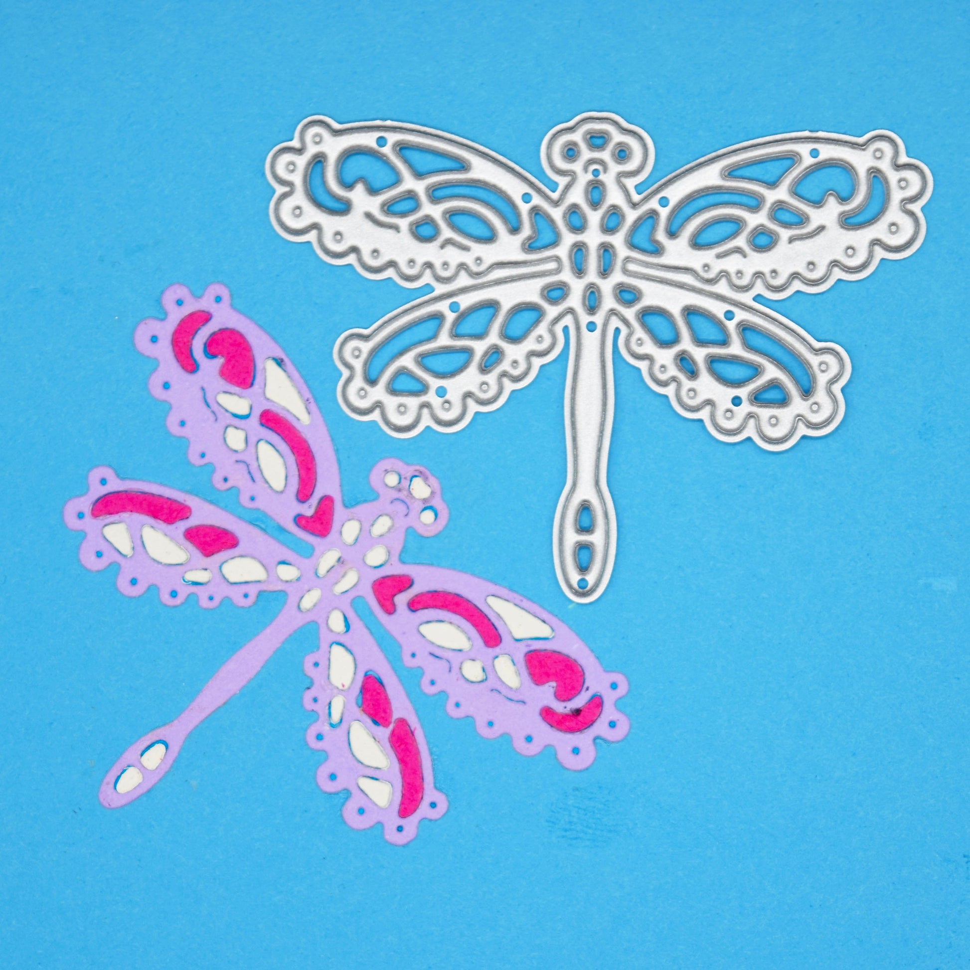 Lace dragonfly metal cutting die shown beside colourful example cut for handmade cards scrapbooking and paper crafts