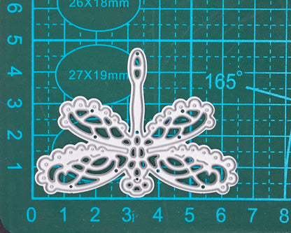 Lace dragonfly metal cutting die on measuring craft mat showing approximate size for card making and papercraft use