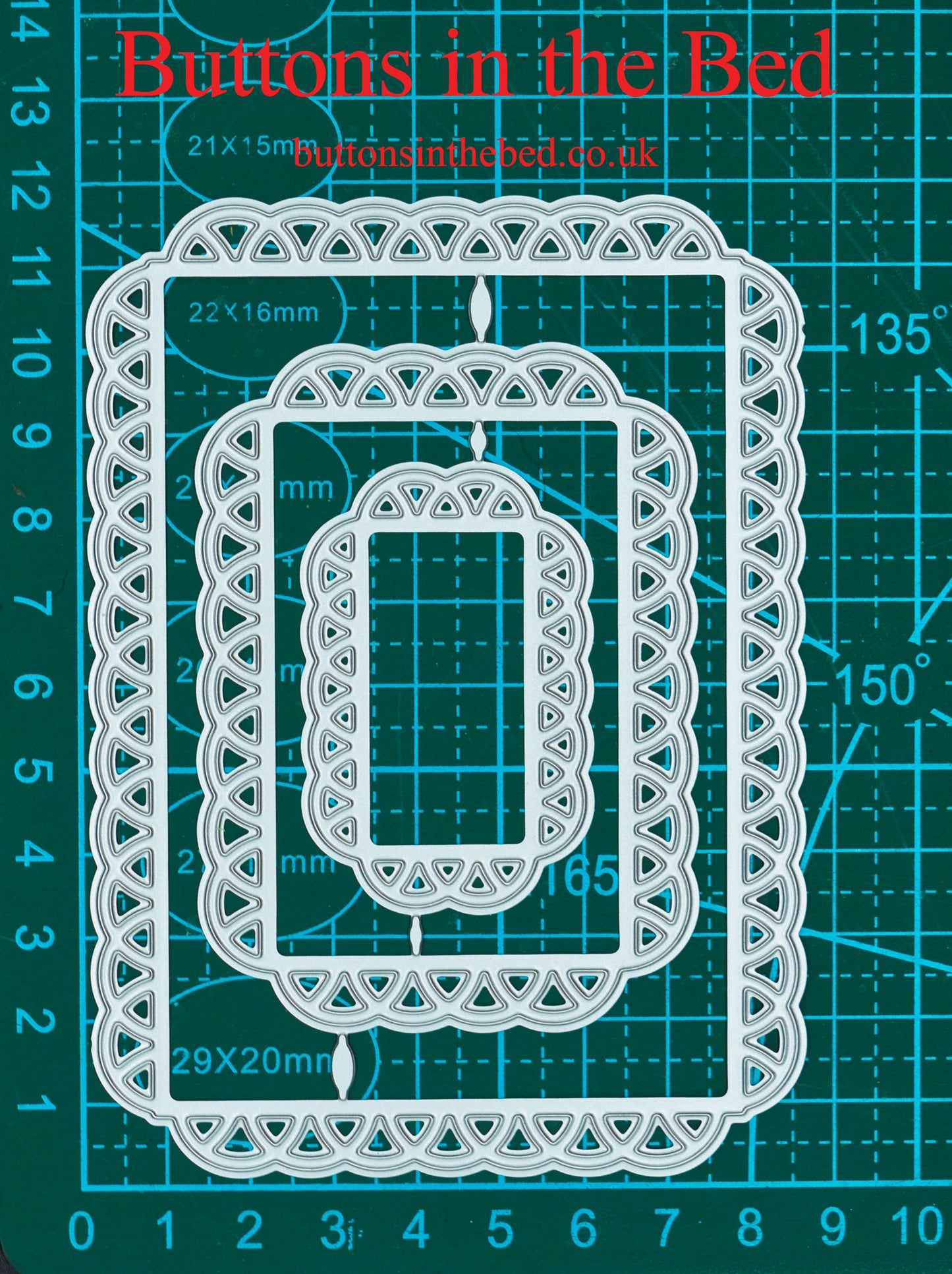 Three decorative lace edge rectangle nesting metal cutting dies shown against a centimetre measurement mat for scale.