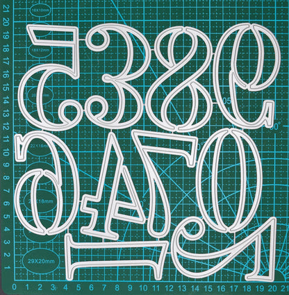 Large number metal cutting dies from 0 to 9 displayed connected on a centimetre cutting mat for size reference