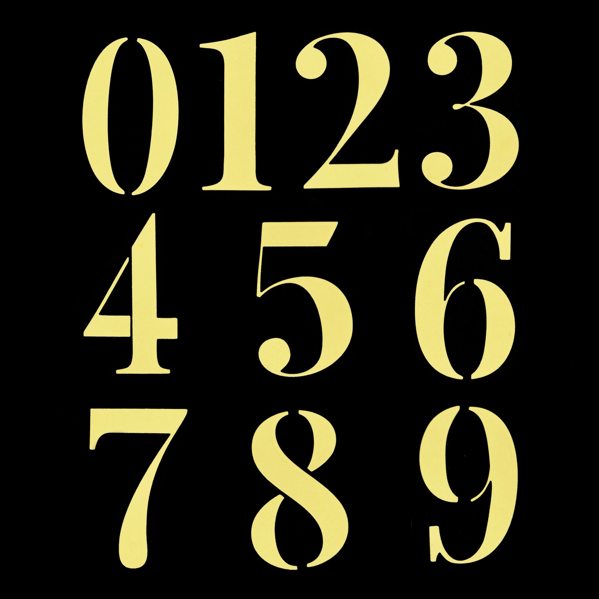 Yellow number die cuts from 0 to 9 arranged on a black background for card making and papercraft