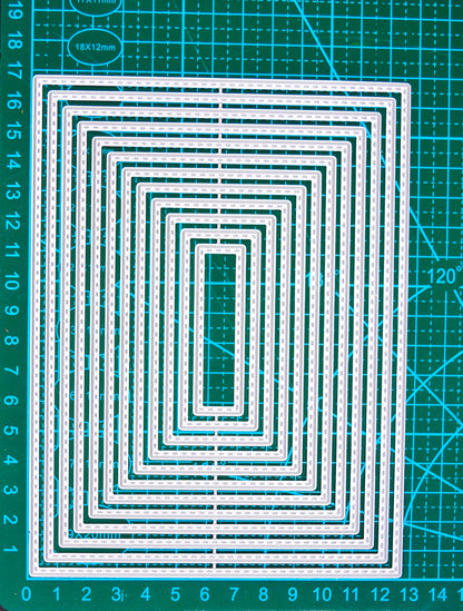 Stitched rectangle nesting cutting dies on a green centimetre cutting mat for size reference.