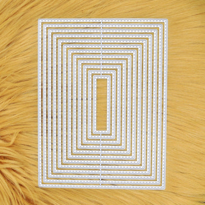 Set of 12 graduated stitched rectangle metal cutting dies displayed on a tan faux fur background.
