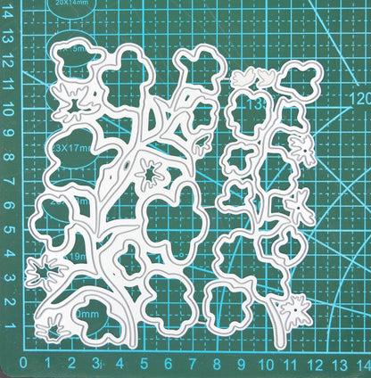 Layered floral stem metal cutting dies on cutting mat showing flower and leaf die sizes for card making